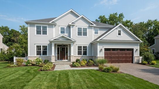 Two-story home clad in new light-grey lap siding with white trim